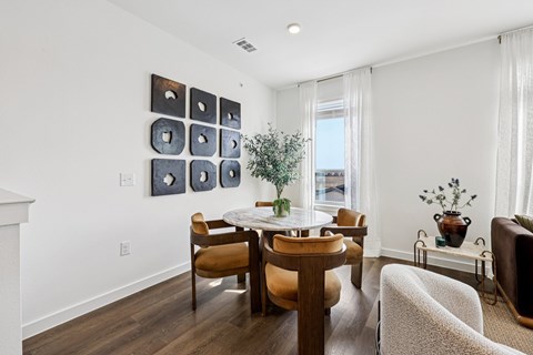 A dining room with a table and chairs.