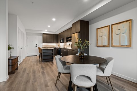 A modern dining room with a table set for two.