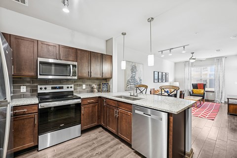 A modern kitchen with wooden cabinets and stainless steel appliances.