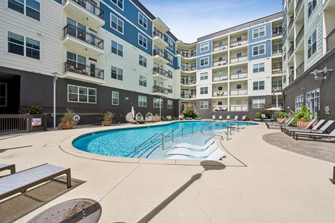 A swimming pool surrounded by apartment buildings.