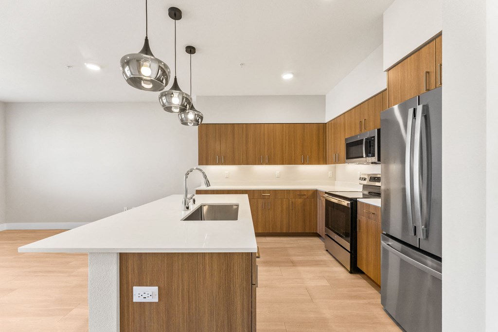 a kitchen with wooden cabinets and stainless steel appliances