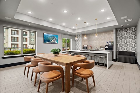 A modern dining room with a wooden table and chairs.
