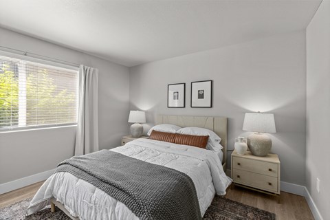 a bedroom with a bed and a large window