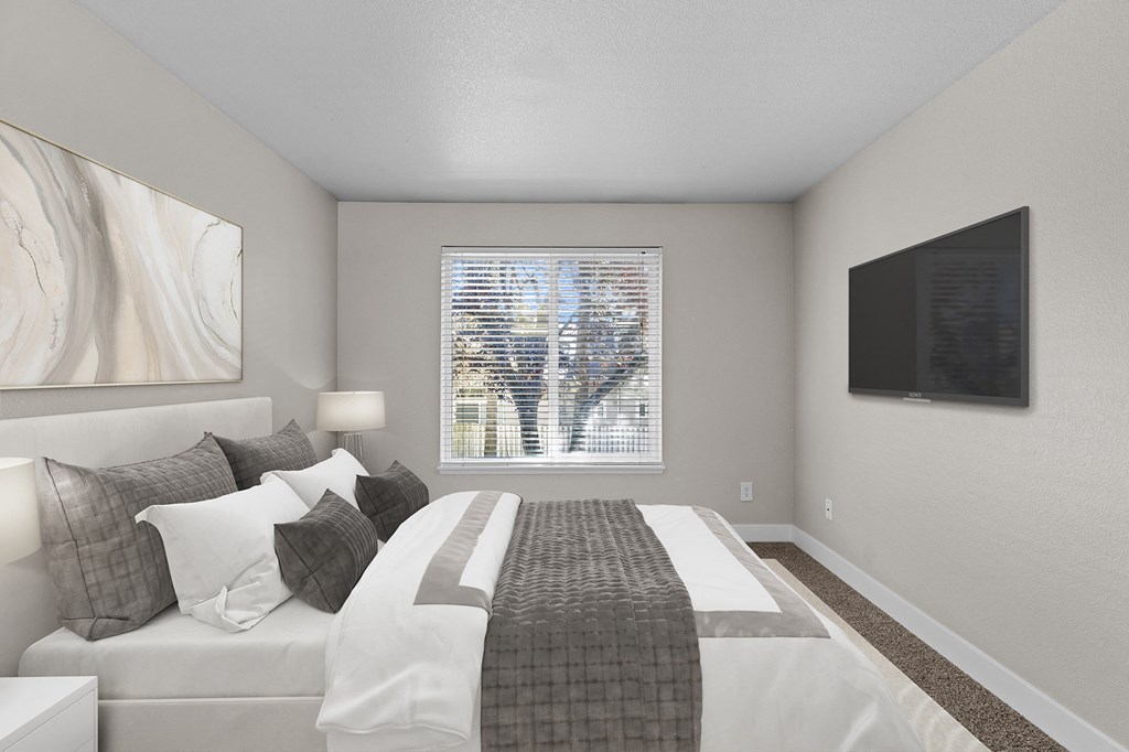 an image of a bedroom with a bed and a window