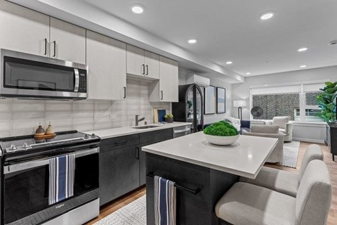 A modern kitchen with a black oven and a white countertop.