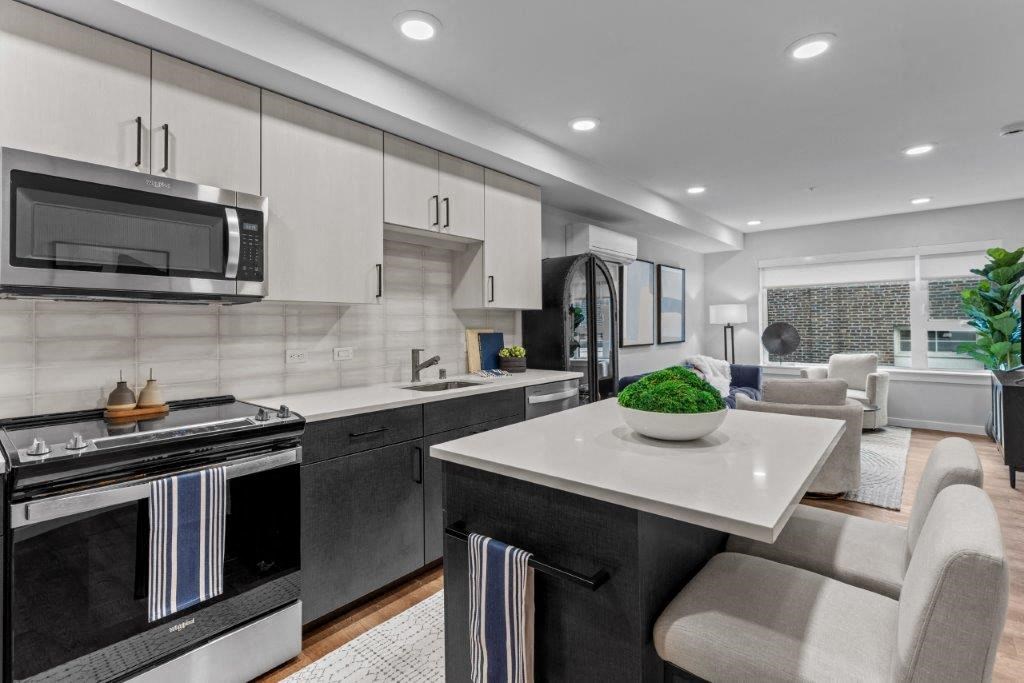 a kitchen and living room with a table and chairs