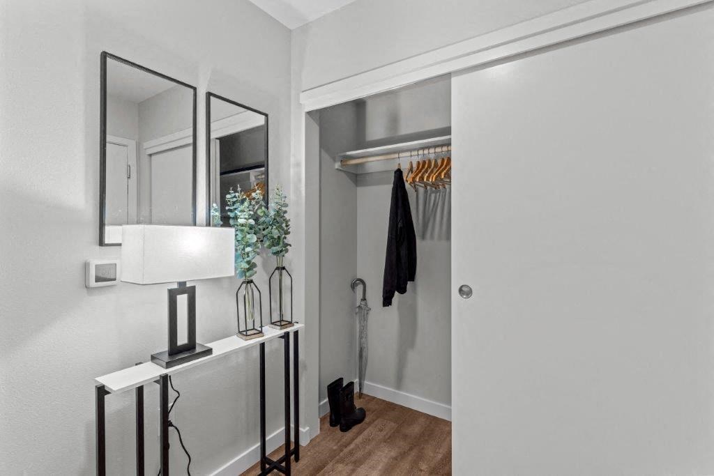 a closet with a mirror and a white door