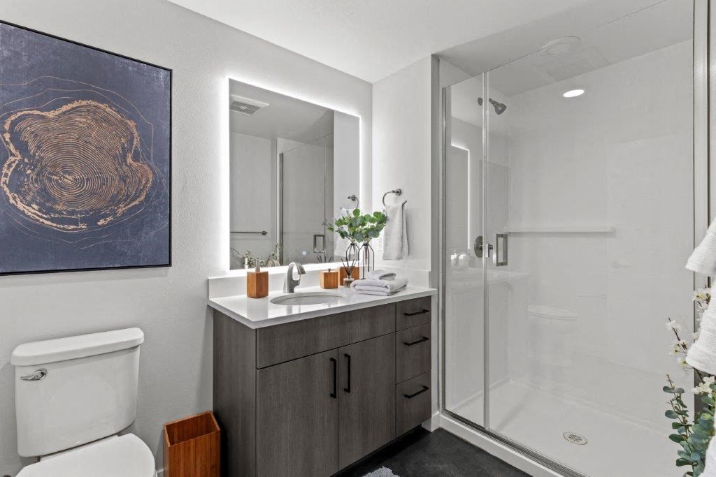 a bathroom with a shower and a sink and a mirror