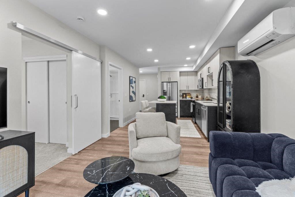 a living room with a kitchen and a couch