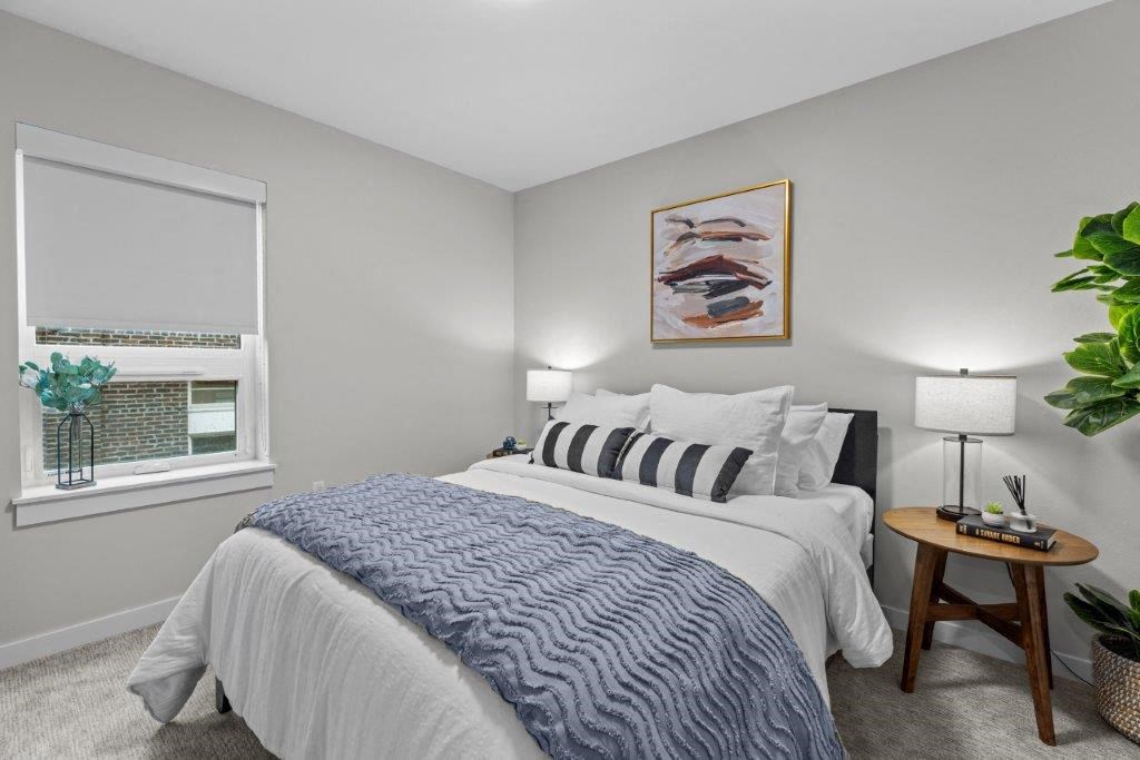 a bedroom with a large bed and a window