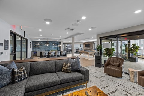 A modern living room with a grey sofa and a coffee table.