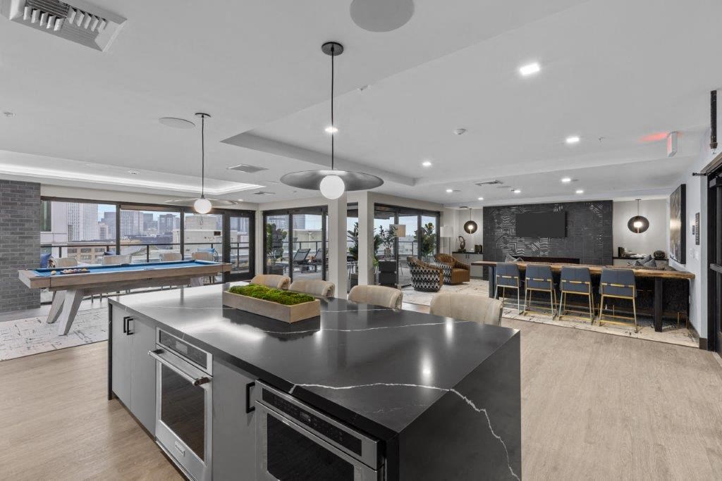 a large kitchen with an island and a pool table