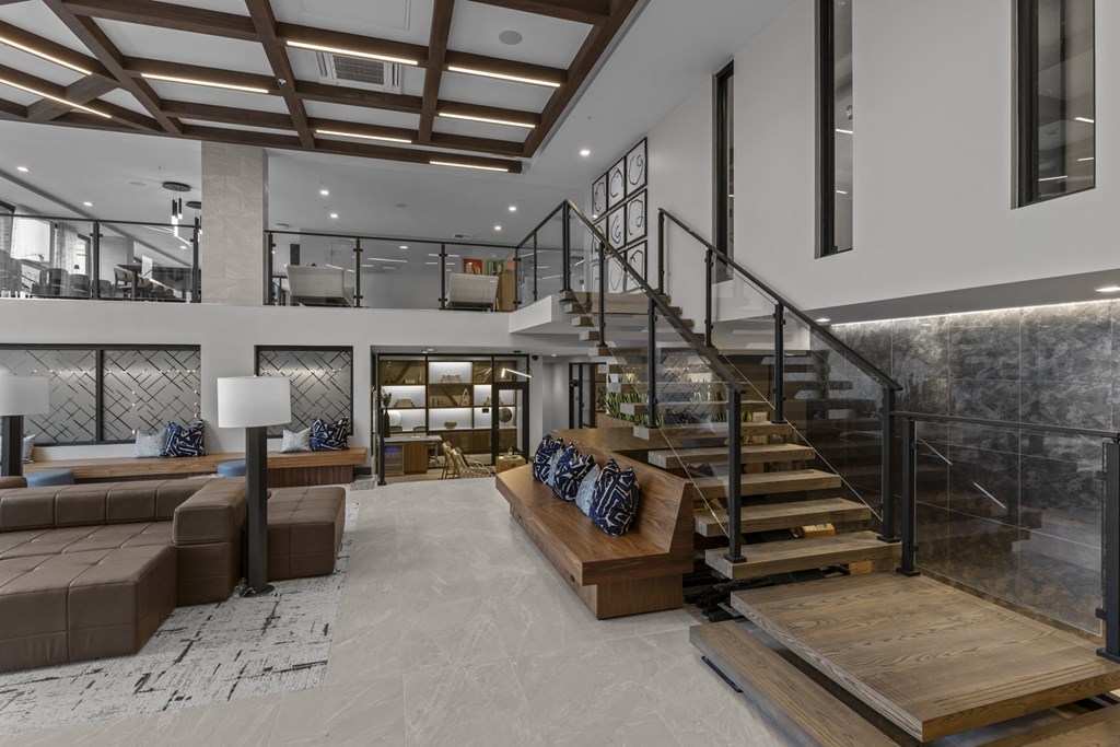 a living room with couches and a staircase