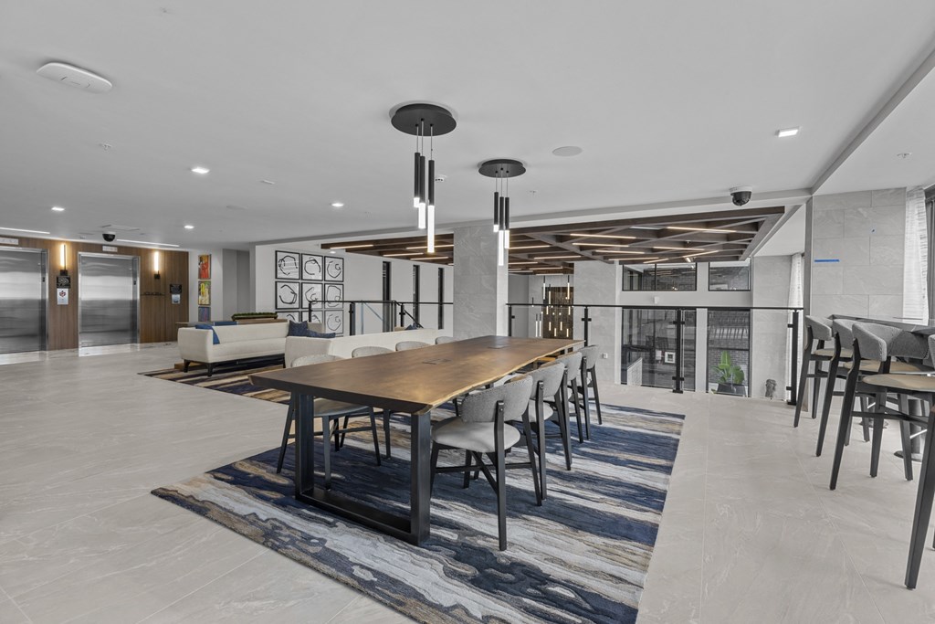 a large dining room with a long wooden table and chairs