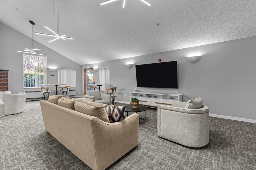 A living room with a large couch and a television.