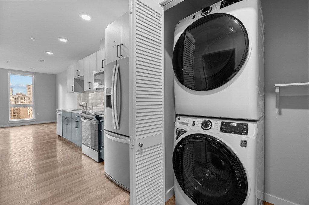 a washer and dryer in a laundry room next to a kitchen