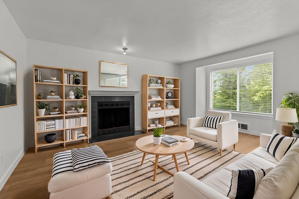 A living room with a fireplace and a coffee table.