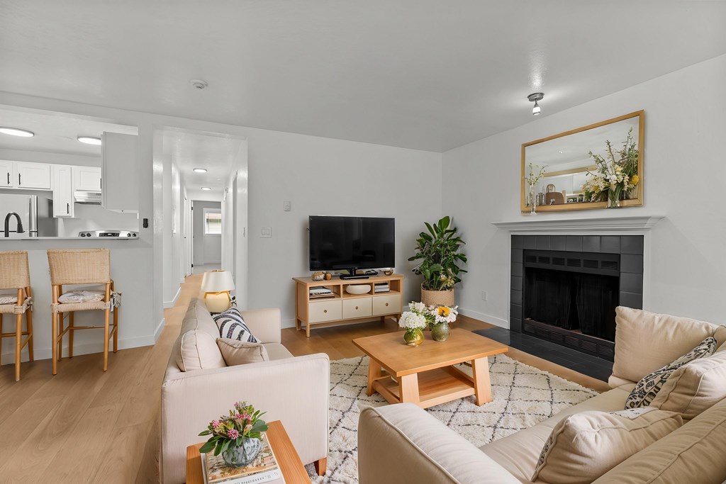 A living room with a fireplace and a television.