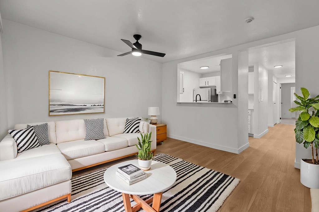 A living room with a white couch and a coffee table.