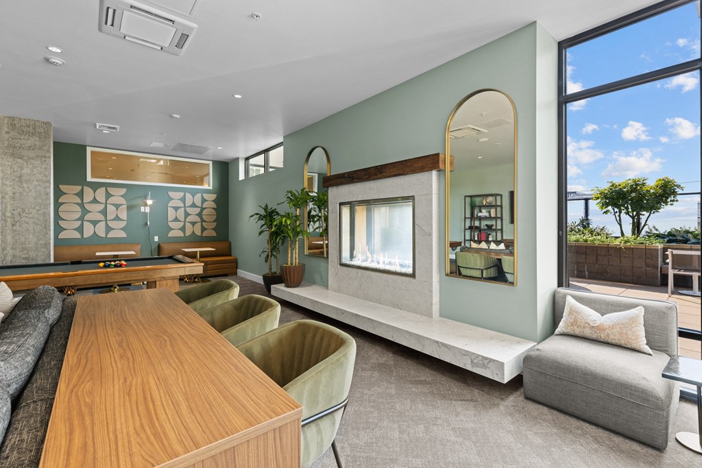 a living room with a table and chairs and a large window