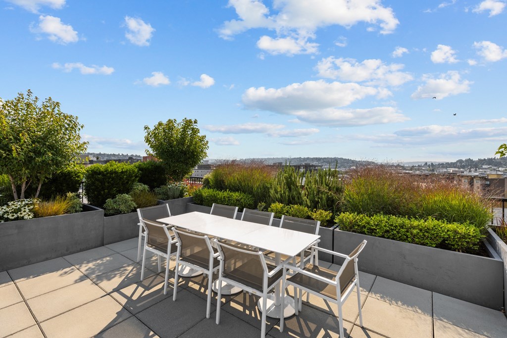 a patio with a table and chairs on a roof