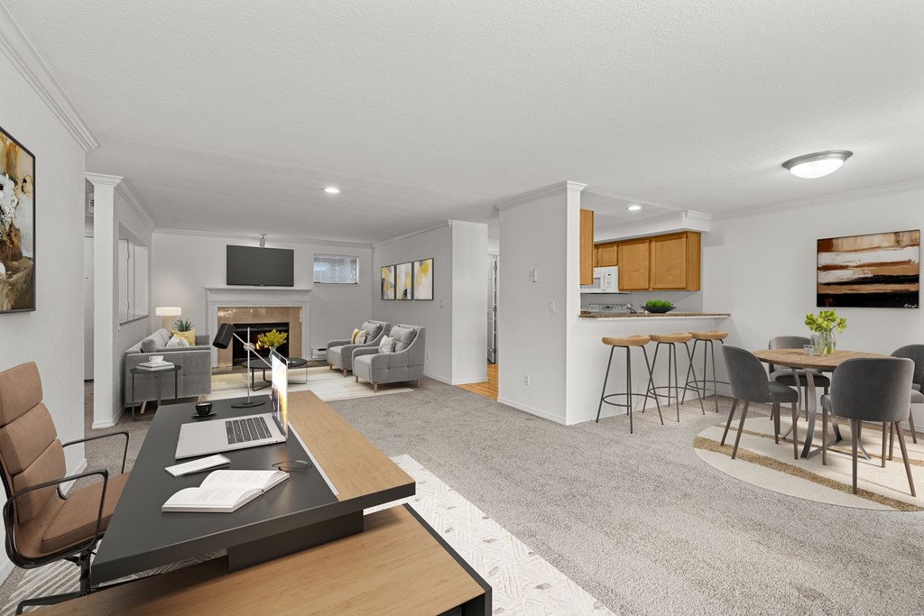 A modern living room with a grey carpet and a wooden coffee table.