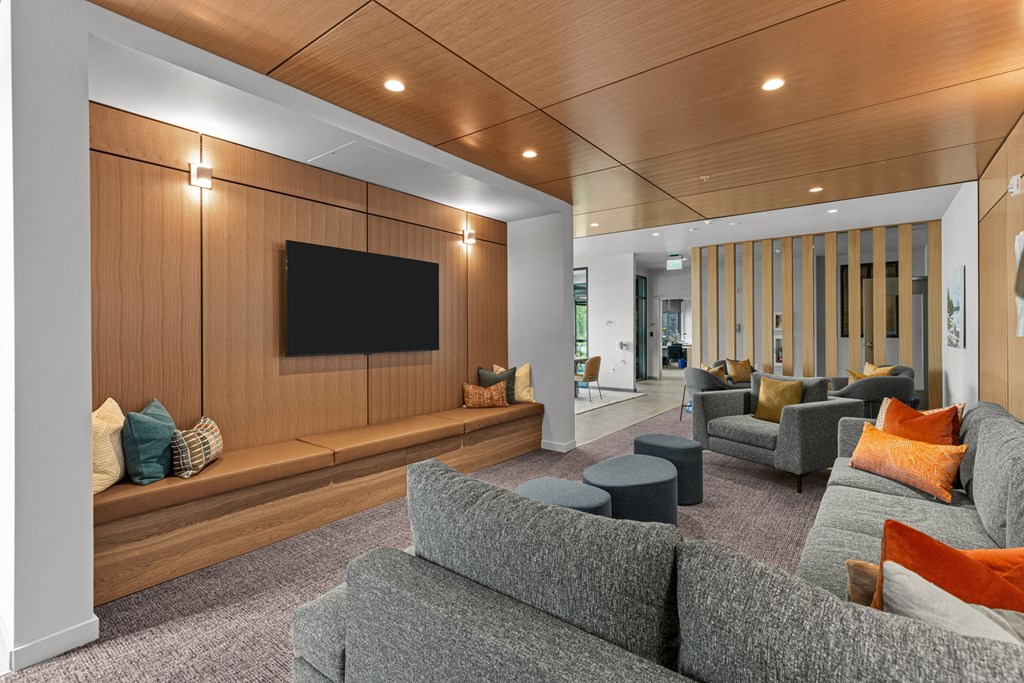 a large living room with couches and a tv