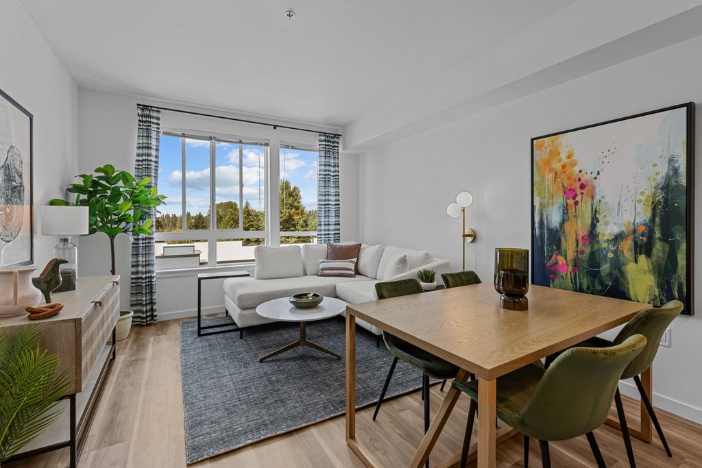 a living room with a couch and a table with chairs