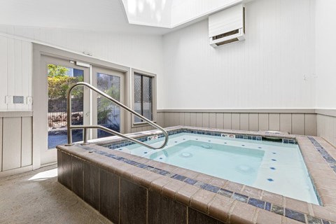 A small indoor pool with a skylight above it.