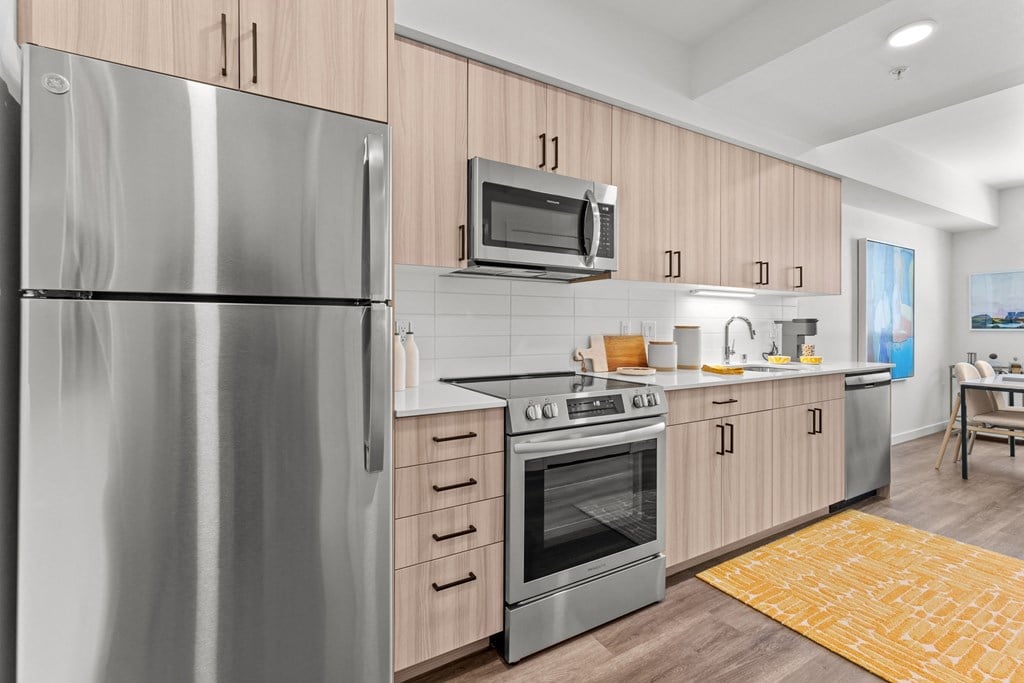 a kitchen with stainless steel appliances and wooden cabinets