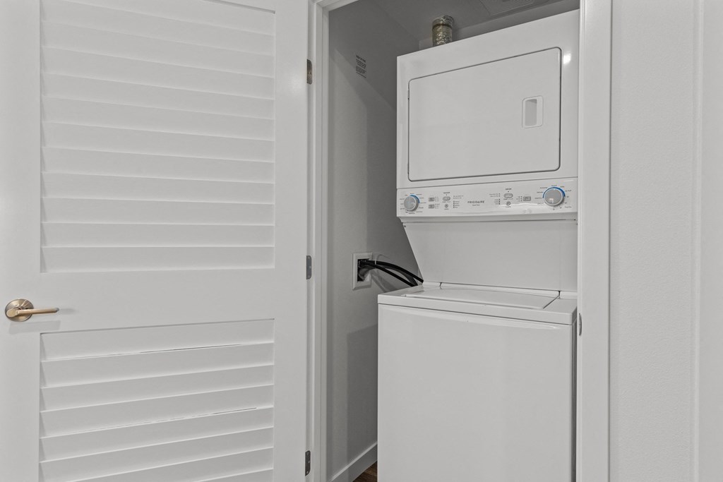 the laundry room has a washer and dryer and a door to the closet