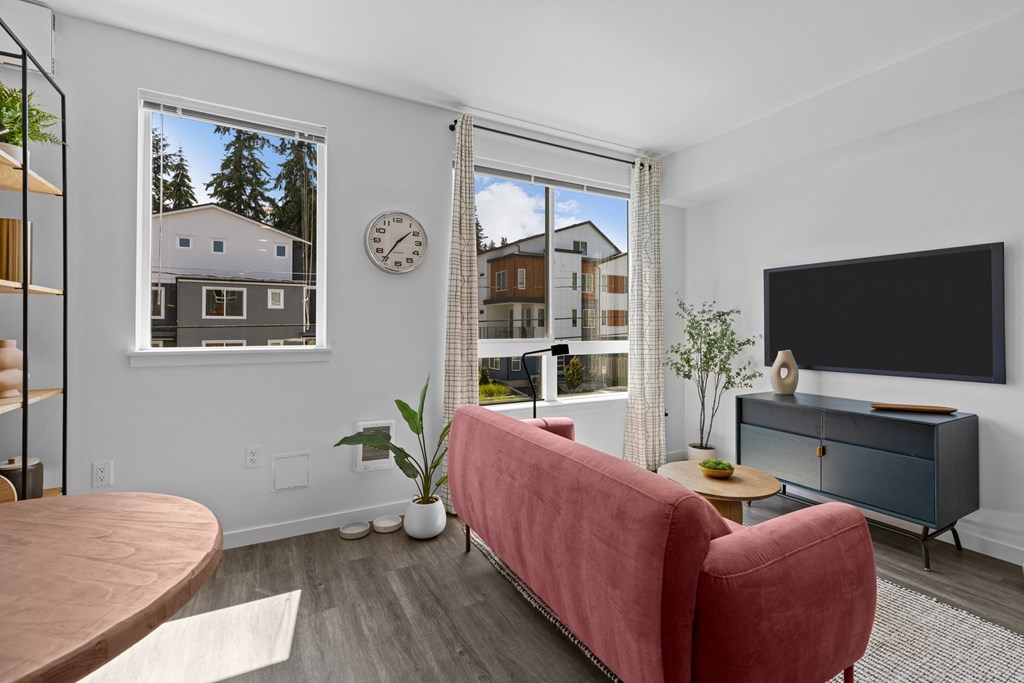 a living room with a red couch and a television