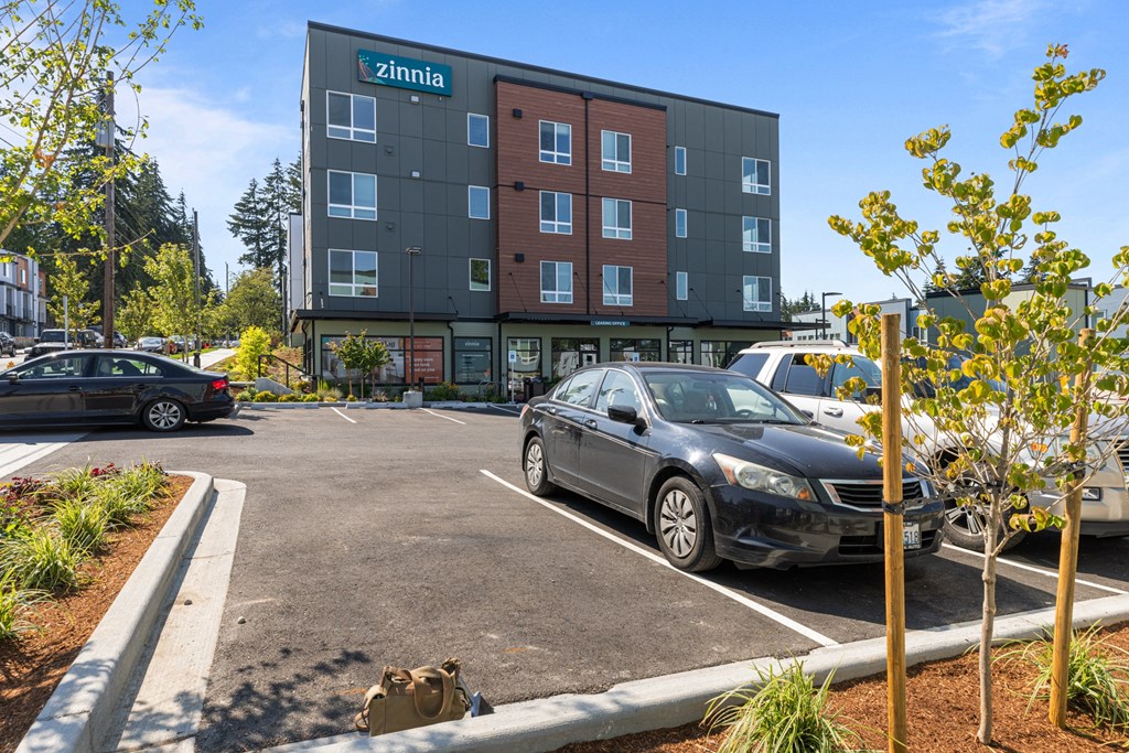 a parking lot with cars in front of a building