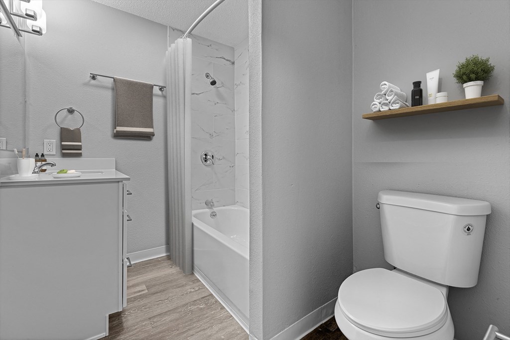 a bathroom with a toilet and a sink and a shower