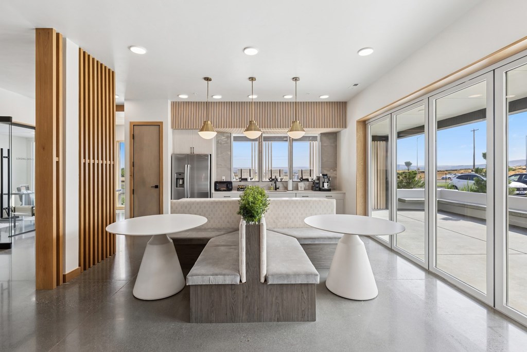 A modern dining area with a table and chairs set up.