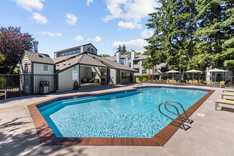 a swimming pool with a house in the background