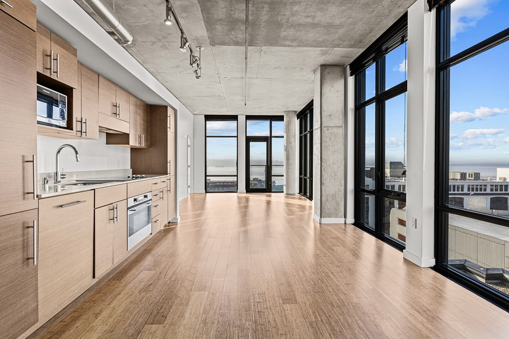 an open kitchen and living room with a view of the city