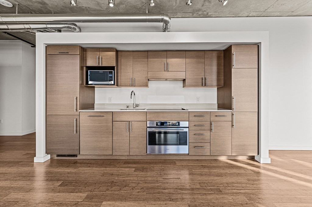 a kitchen with wooden cabinets and stainless steel appliances