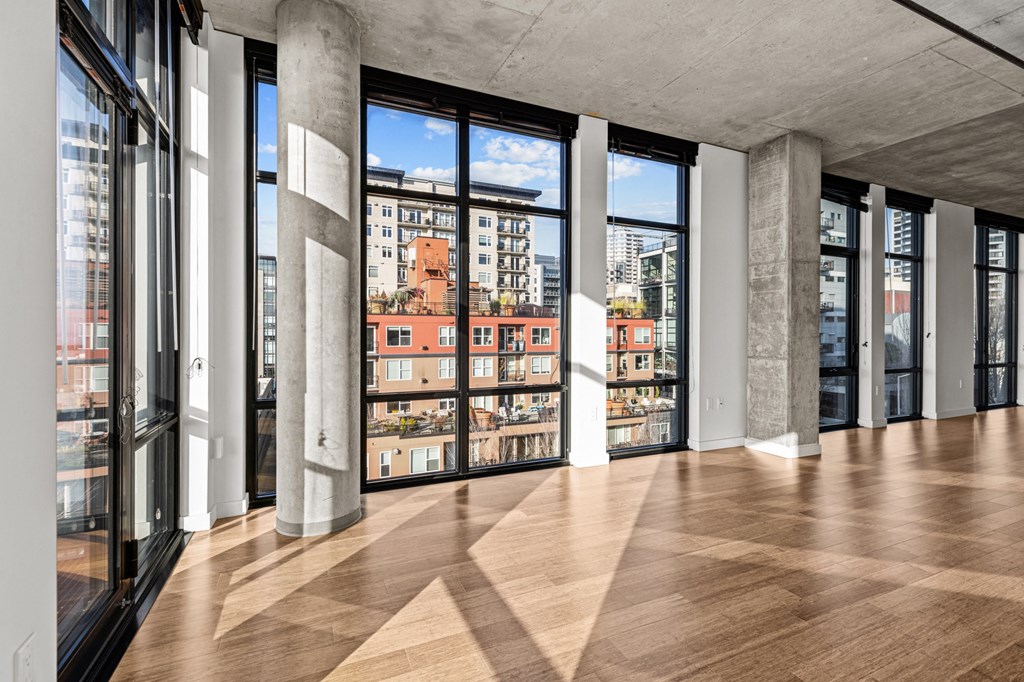 a view of the city from a large living room in a building with tall windows