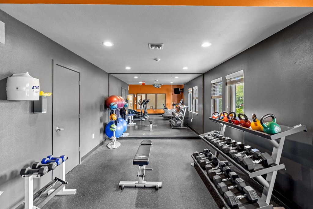 a workout room with weights and other exercise equipment
