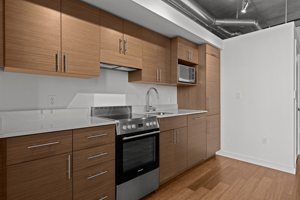a kitchen with wooden cabinets and stainless steel appliances