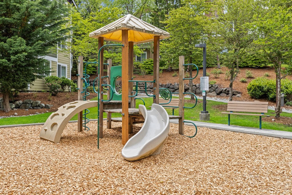 a playground with a swing set and slides