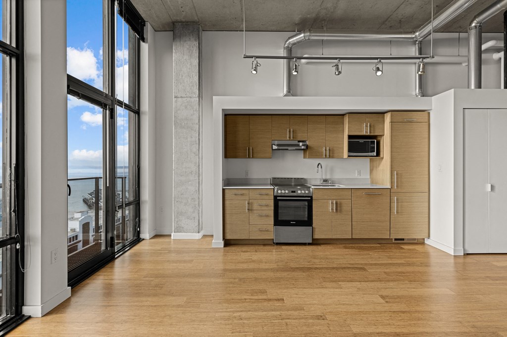 a kitchen with wooden cabinets and a stove and a window