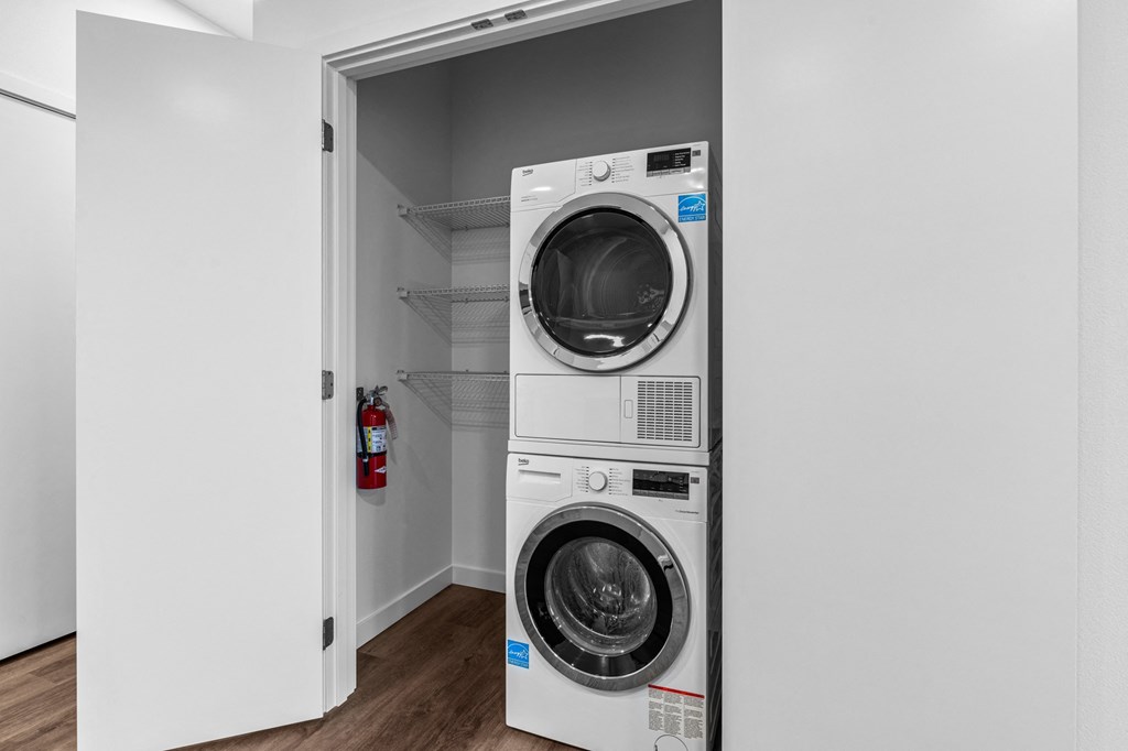 a front loading washer and dryer in a laundry room
