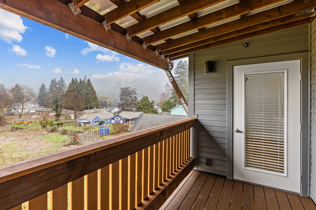 the view from the deck of a home with a white door and a porch