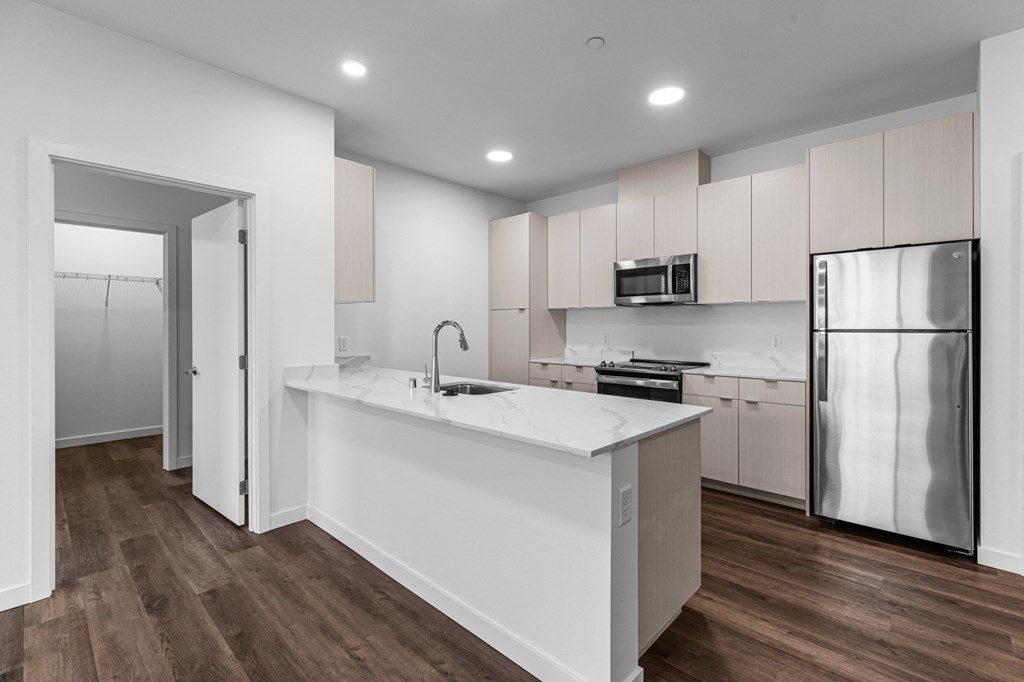 a kitchen with white cabinets and a white counter top