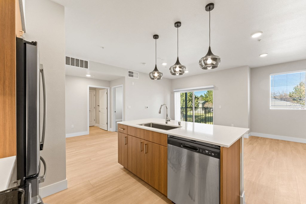 a renovated kitchen with a large island and stainless steel appliances
