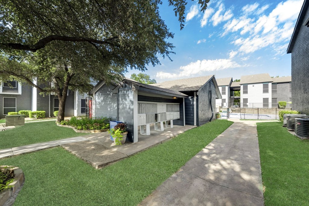 our apartments have a spacious yard with grass and a sidewalk