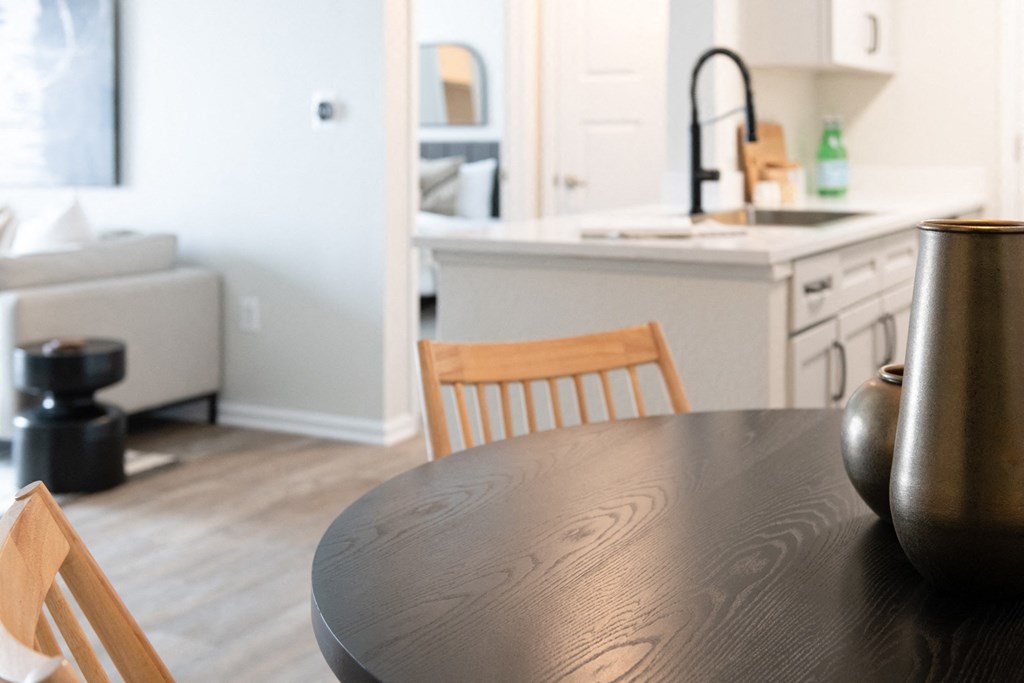 a kitchen with a wooden table and chairs