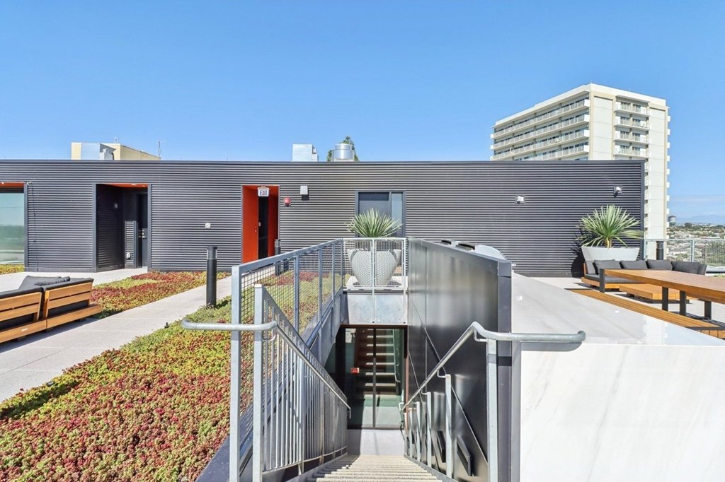 A modern building with a metal staircase leading to the entrance.